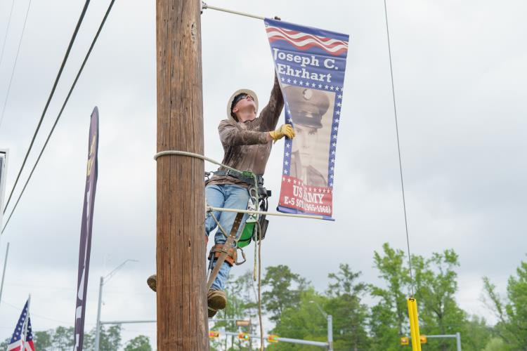 attachment image-Utility Line Students Install Kountze Veteran Banners in Honor of Memorial Day